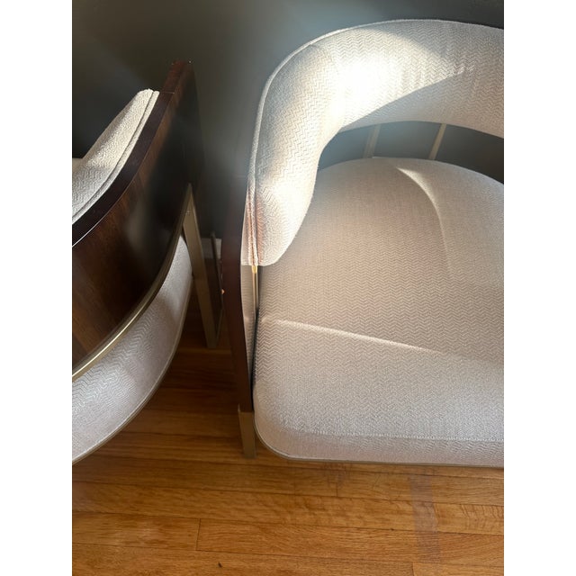 Elevate your interior with this sophisticated pair of Caracole “Streamliner” accent chairs (SKU: M020-417-132-A), a...