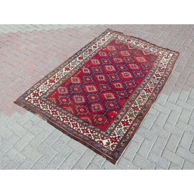 This beautiful, traditional vintage, hand knotted Turkish area rug is approximately 60 years old. It is handmade of very...