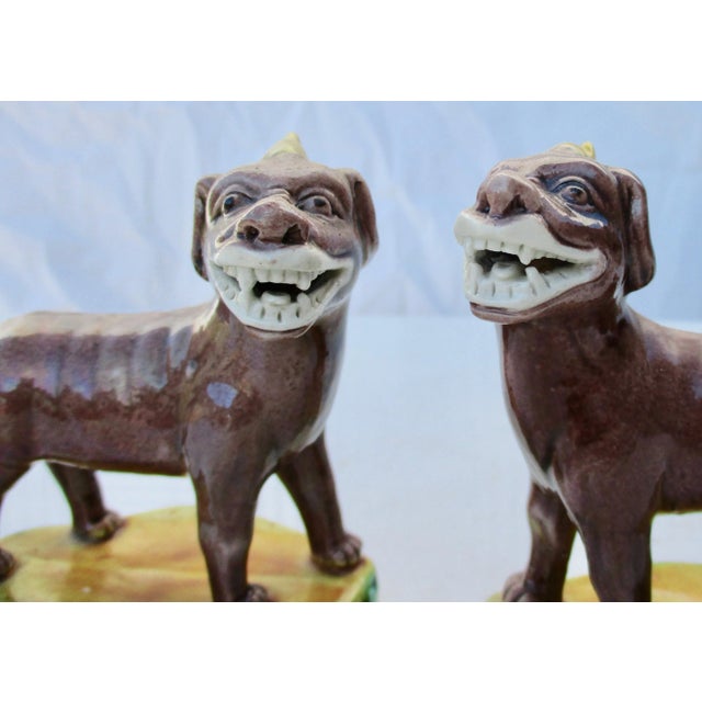 Charming pair of Chinese porcelain standing kylins on high floral medallion bases. Glazed in tri-color Brown, green and...