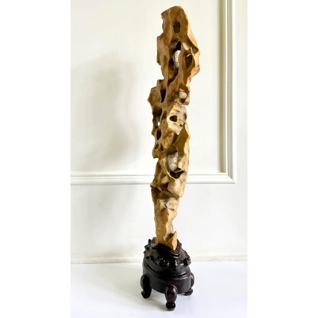 A very tall and slender Chinese scholar rock of Taihu type in an elegant Lingzhi mushroom form well-balanced on a custom-...