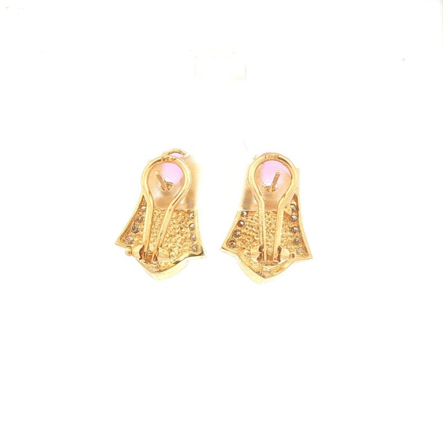 A pair of contemporary earrings crafted in 14k gold. Featuring oval-cut pink sapphires, totaling 2.94 carats, set...