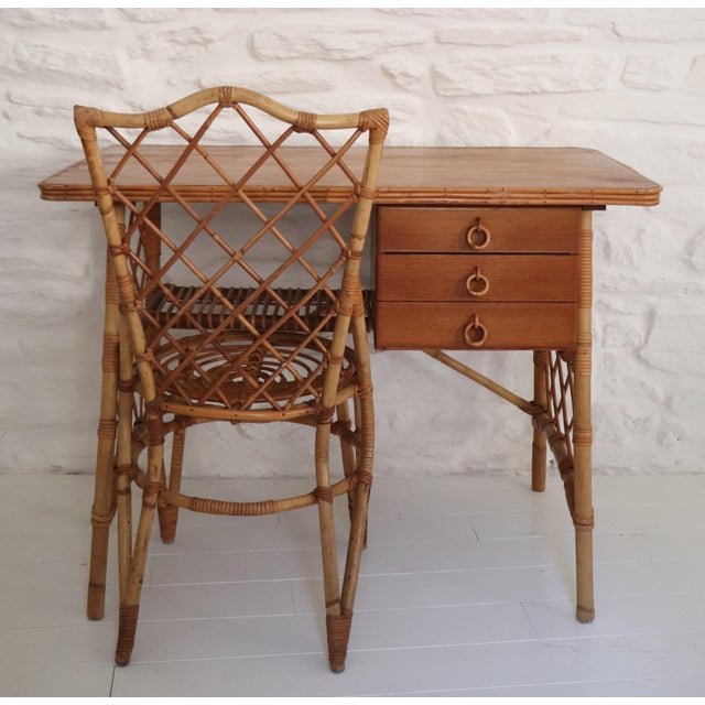 A woven rattan desk and its original chair. Characteristic of Louis Sognot's work, this set combines functionality, clean...