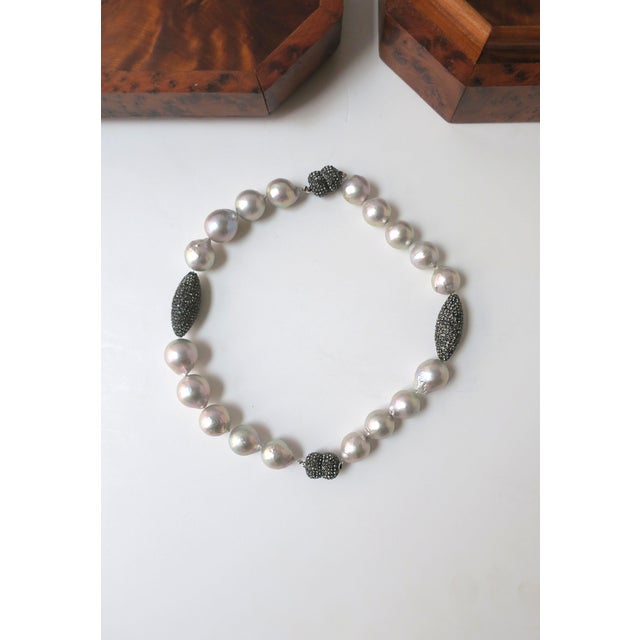 A baroque light-gray pearl collar necklace with charcoal crystal‑encrusted accent beads, that converts into two bracelets,...