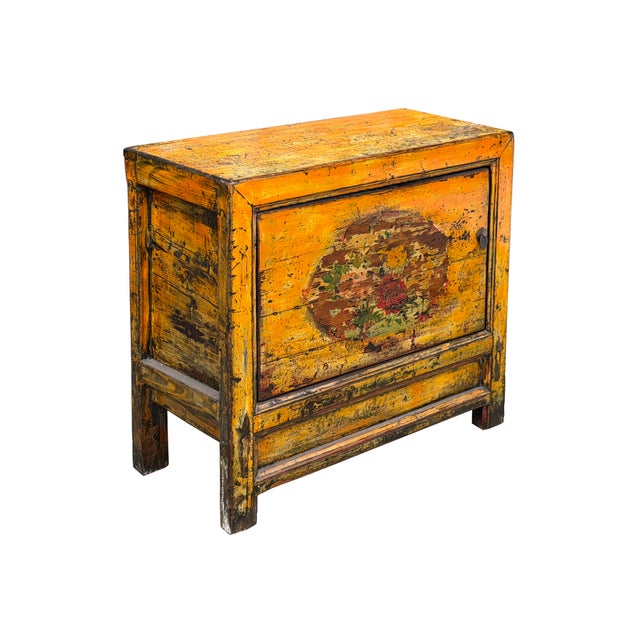 This striking antique Asian cabinet features a vibrant, heavily distressed yellow lacquer finish over a sturdily built...