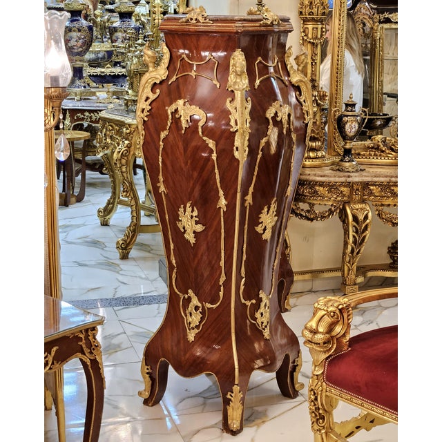Make a dramatic statement with this exceptionally ornate French-style pedestal, featuring a rich polished wood finish,...