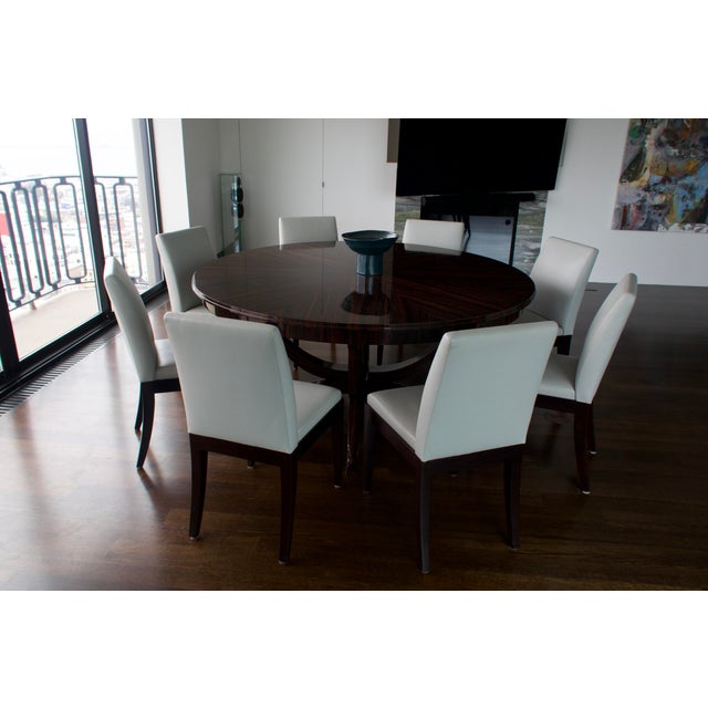 Custom-made round extendable dining table from a gallery, paired with 12 Christian Liaigre for Holly Hunt leather dining...