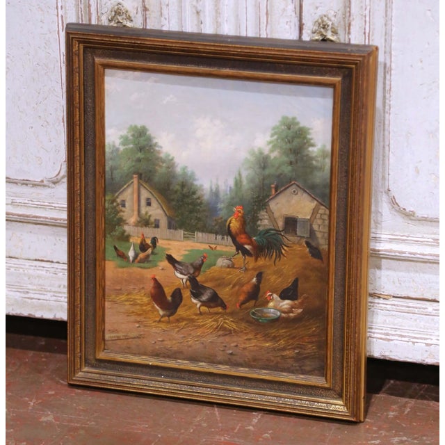 This charming antique oil painting depicts a lively English farmyard scene centered around a proud rooster perched atop a...
