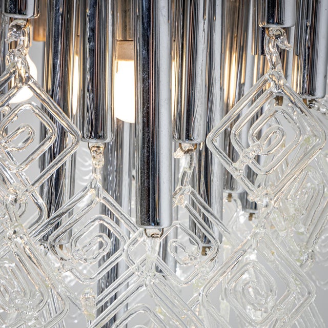 Modern floor lamp on a conical metal base with straight stem. The light fitting comprises cylindrical rods of varying...