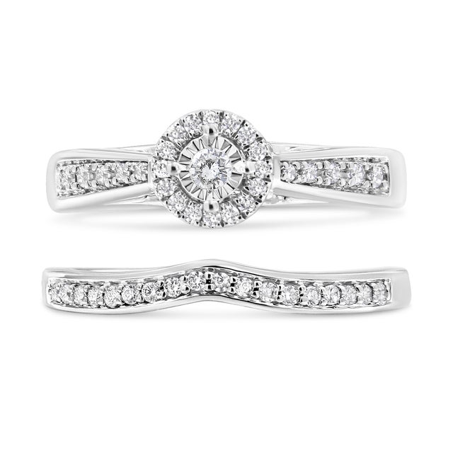 Immerse yourself in the timeless elegance of this rhodium-plated .925 sterling silver engagement ring set, where classic...