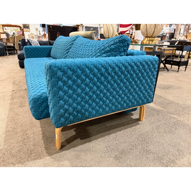 Bring vibrant Scandinavian-inspired style and everyday versatility into your home with this striking teal sleeper sofa...