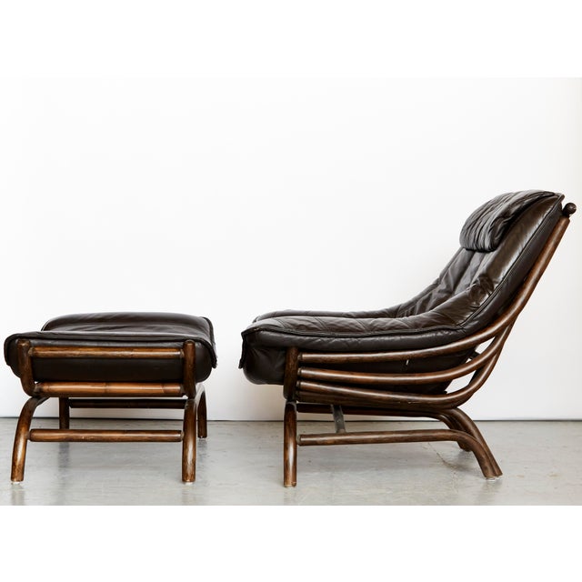 Beautiful and extremely comfortable lounge chair with matching footstool. The loose cushions are upholstered in genuine...