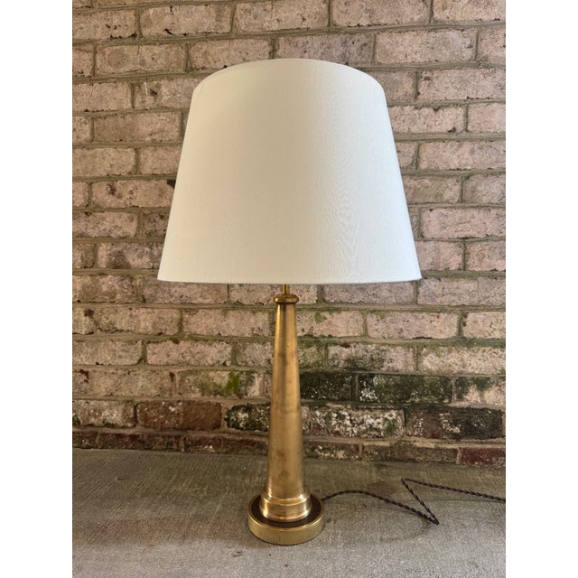 A solid brass vintage firehose nozzle turned into a table lamp. This vintage firehose nozzle was secured to a custom wood...