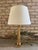 A solid brass vintage firehose nozzle turned into a table lamp. This vintage firehose nozzle was secured to a custom wood...