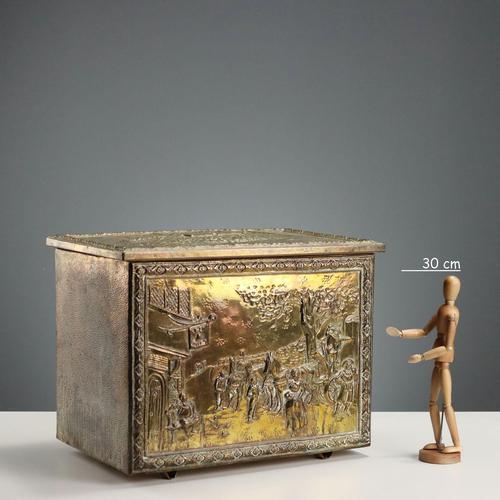 A firewood storage chest made of iron covered with gilded, embossed, and burin-worked sheet metal. Decorated with...