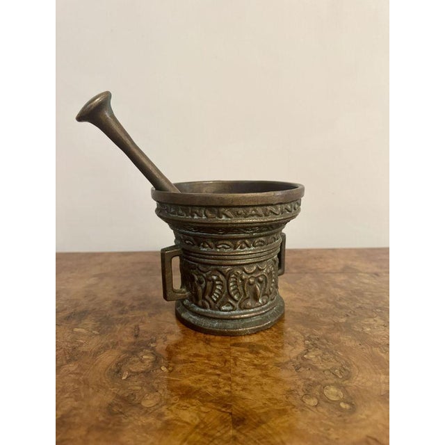 Quality antique bronze pestle and mortar, having a quality antique bronze pestle and mortar the mortar with raised...