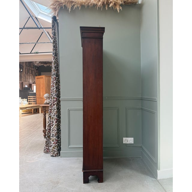 This edwardian-style english display bookcase captivates with its slender form, small-paned door, and deep, dark patina. A...