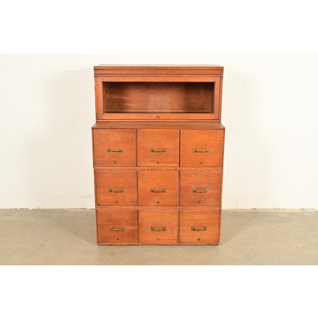 An exceptional antique Mission or Arts & Crafts 9-drawer file cabinet with barrister bookcase In the manner of Globe...