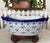 An eye-catching blue and white porcelain bowl with Fleur-de-lis design, elevated on a wooden stand. Circa late-20th...
