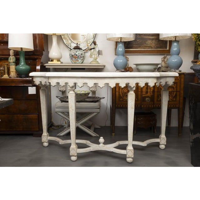 This is a sophisticated Swedish console table featuring a beautifully shaped white faux marble top resting on an elegant...
