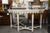 This is a sophisticated Swedish console table featuring a beautifully shaped white faux marble top resting on an elegant...
