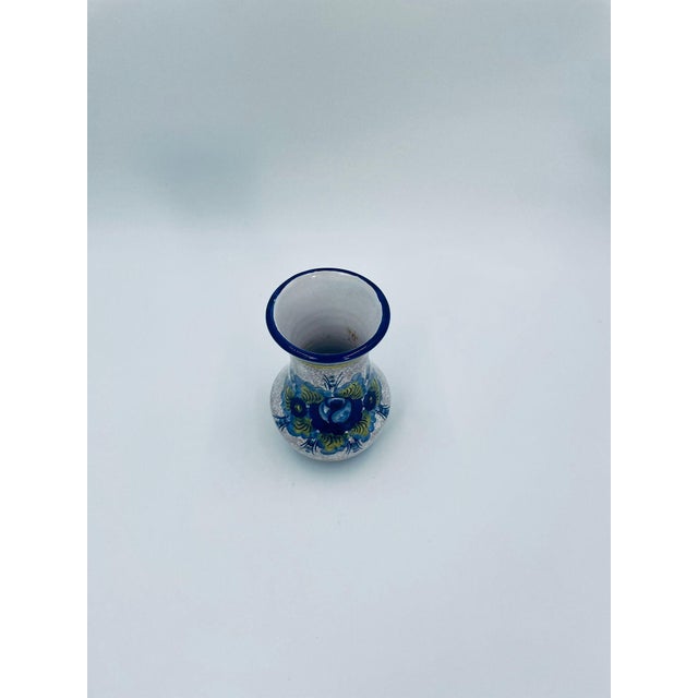 A decorative vase of Italian origin, crafted from high-quality ceramic. Featuring a traditional, contoured silhouette with...