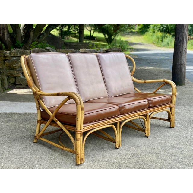 A Hollywood Regency Boho Rattan Settee Sofa, c. Mid 20th Century. This Rattan Loveseat would look exceptional while...