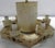 Six candelabras are mounted on a hexagon base with hand painted details. The base is topped with a metal slant shade with...