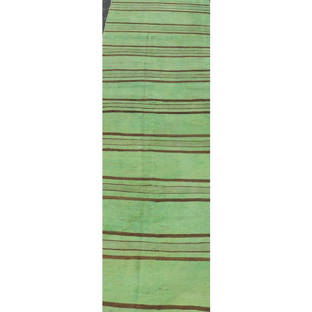 Measures: 2'9 x 12'1 This vintage Turkish kilim runner features a striking design with bold green and brown stripes. The...