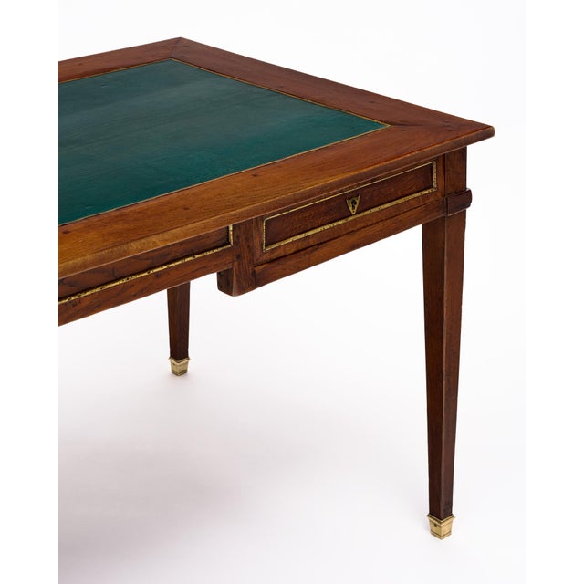 Elegant French Louis XVI provincial bureau plat crafted in solid oak, with a beautifully restrained neoclassical design....