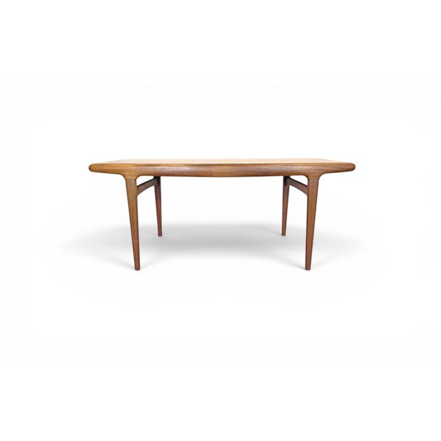 Designed by Johannes Andersen, this teak draw leaf dining table embodies the practical ingenuity of Danish design, with...