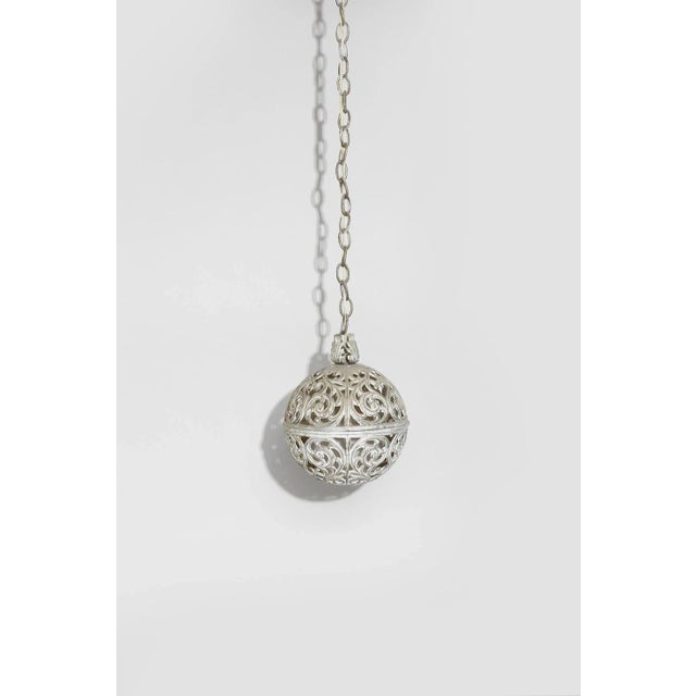 Mid-century filigree sphere pendant lamp with glass globe interior. Hardwired. Both lamps are in working condition....