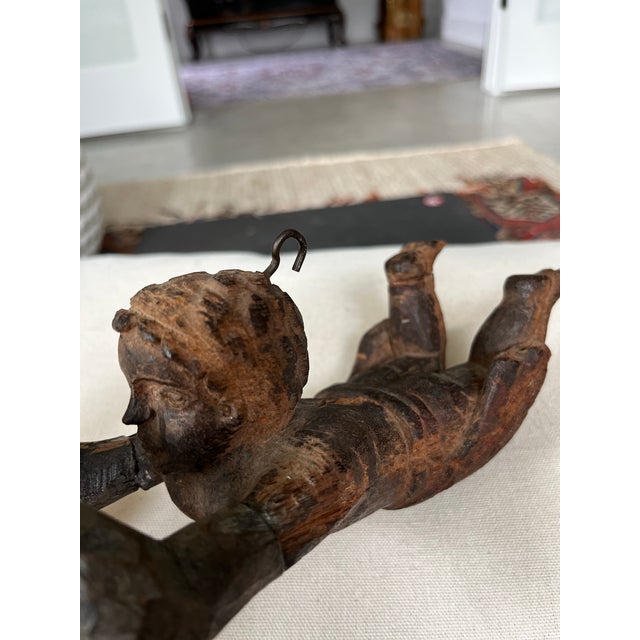 This cherub sculpture was hand-carved in France at latest the late 18th Century. It represents a traditional cherub, a...