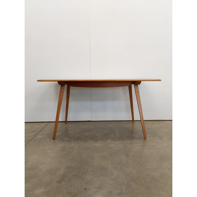 Authentic vintage plank dining table. Model 382 by Ercol (unmarked). Solid elm wood top and beech wood legs. This piece is...