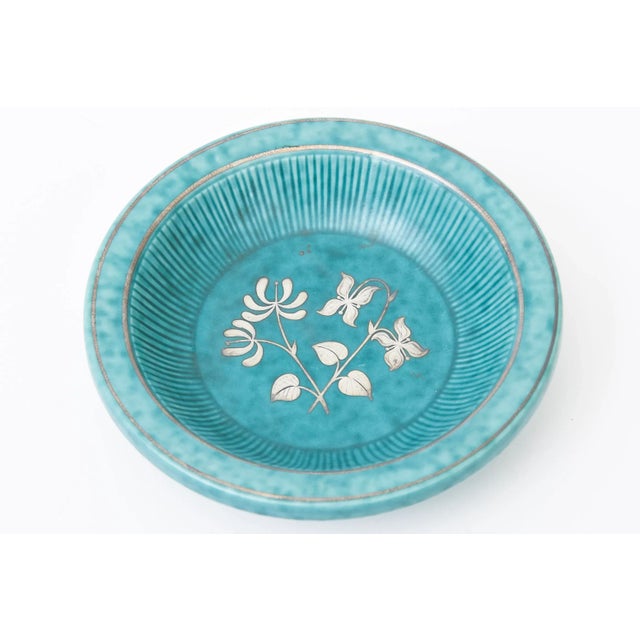 This vintage ceramic Argenta turquoise green stoneware bowl with applied sterling silver flowers and leafs was designed by...