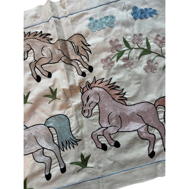 Hand-embroidered Suzani panel from Uzbekistan, worked in fine floss on a cream cotton ground. Six pastel horses move...
