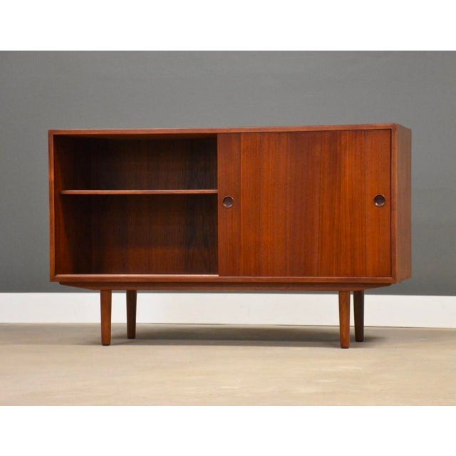 A mid century modern teak sideboard credenza with two sliding doors designed by Børge Mogensen for Karl Andersson and...