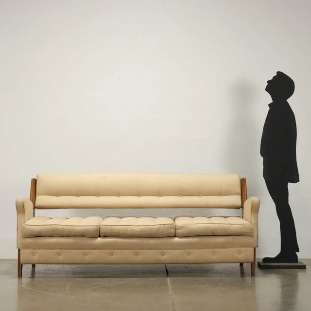 Vintage 1950s-60s Italian-made three-seater sofa with a sinuous shape with a particular wooden structure and original...