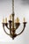 Wonderful cast bronze eight-light Gothic Mission chandelier having male heads on the outer arms, and column capitals on...