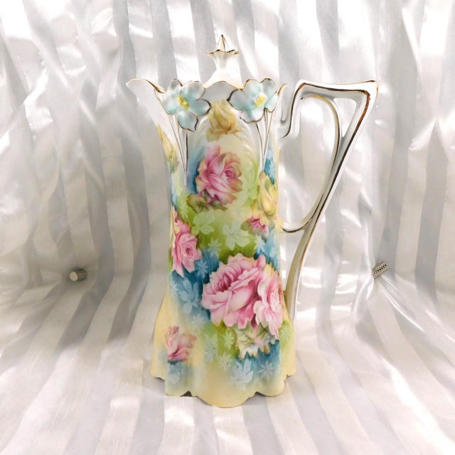 This is an unmarked floral chocolate pot that screams Reinhold Schlegelmilch. The pot has the shaping, including the...