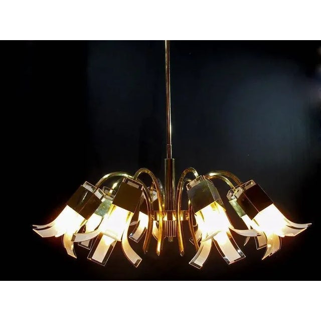 Elegant chandelier composed of eight arms. This piece is attributed to the mentioned designer/maker. It has no attribution...