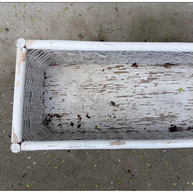 A charming vintage white Wicker rectangular planter stand in white painted wicker with rattan accents. Nearly impossible...