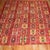 Vintage Turkish Kilim with a colorful repetitive square design on a cherry red colored ground. Measures: 8'10" x 10'11".