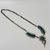 This necklace tells a story of craftsmanship, with its delicate needlepoint turquoise petals forming a radiant flower,...