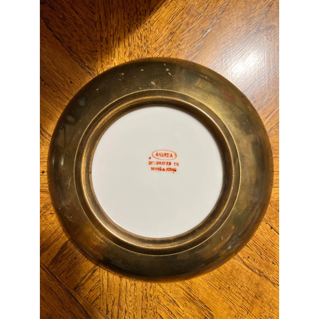 Vintage Chinoiserie brass encased bowl with rider on white horse design, orange background, surrounded by greek key...