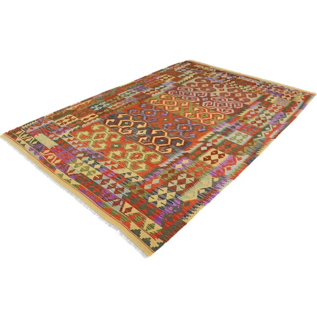 Add a touch of elegance to your home with this casual chic hand woven Tribal Kilim wool rug. Constructed on a loom by...