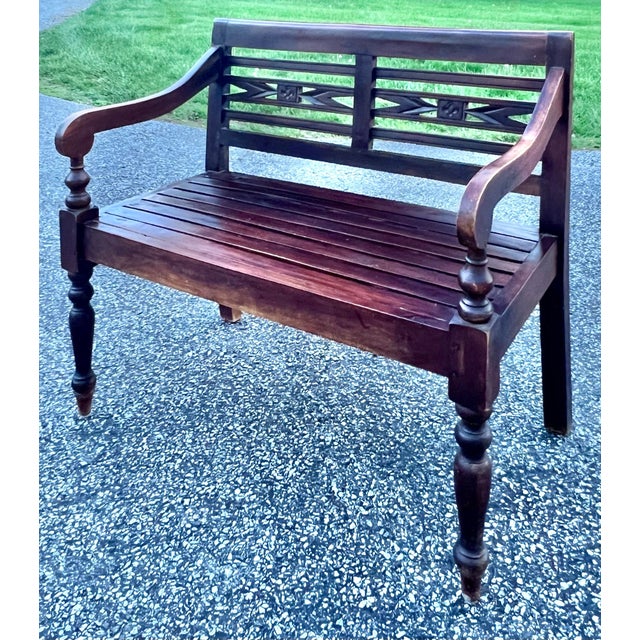 Solid teak bench from Bali. . Slatted seat with nice scrolled arms and back with carved detail. Nicely turned legs. The...