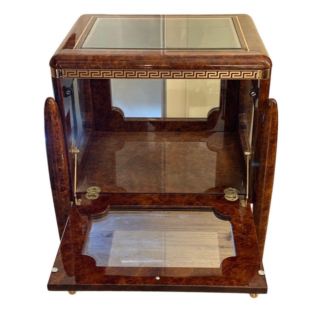 A striking 20th-century display curio vitrine table in the Italian Neoclassical and Versace-inspired taste. The richly...