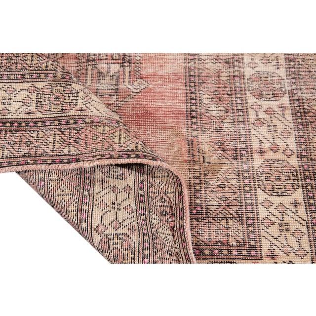 Beautiful Vintage hand-knotted wool rug with a red field. This rug has accents of brown and beige in a gorgeous all-over...