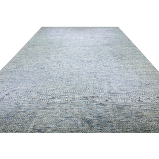 Beautiful Contemporary Savannah hand-knotted wool rug with a finely detailed light blue field in an all-over white...