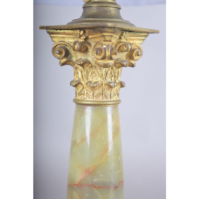 A remarkable 19th-century table lamp crafted from finely polished onyx marble, designed in the form of a classical...